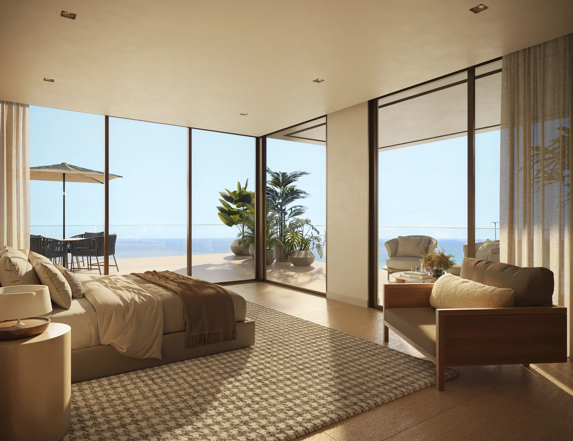 Suíte da penthouse triplex com poltronas e vista para o mar