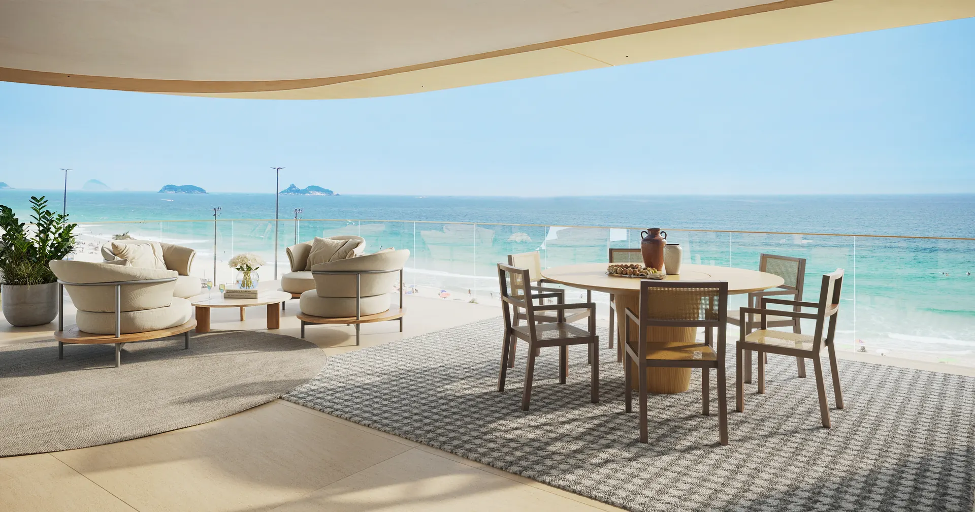 Varanda com mesa e poltronas, com a praia da Barra à frente