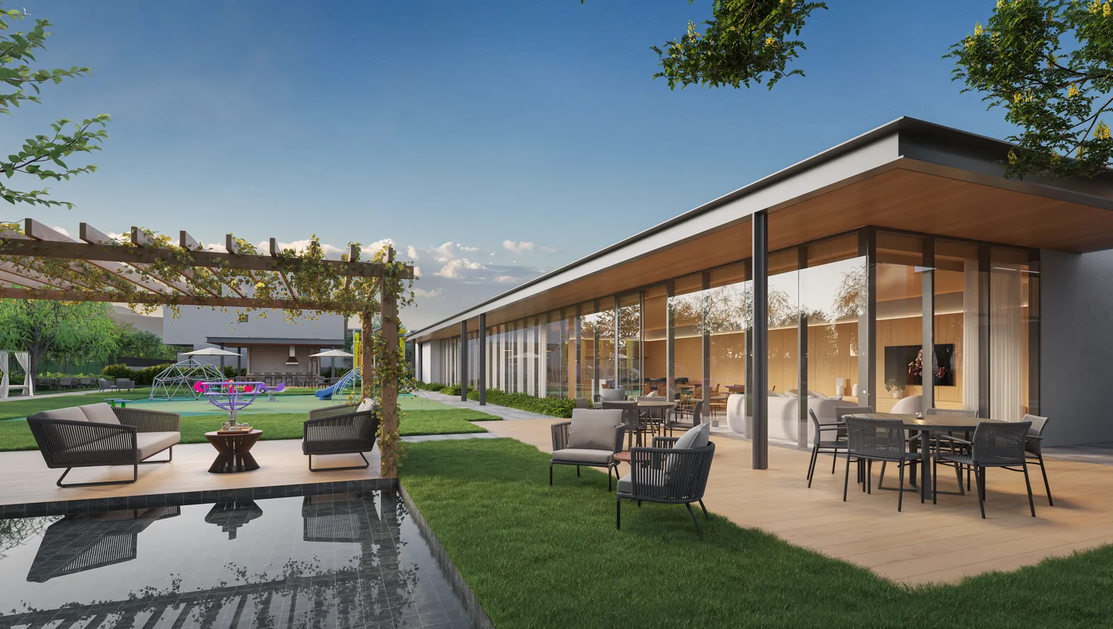 Deck lounge com poltronas, espelho d’água e o espaço gourmet ao fundo