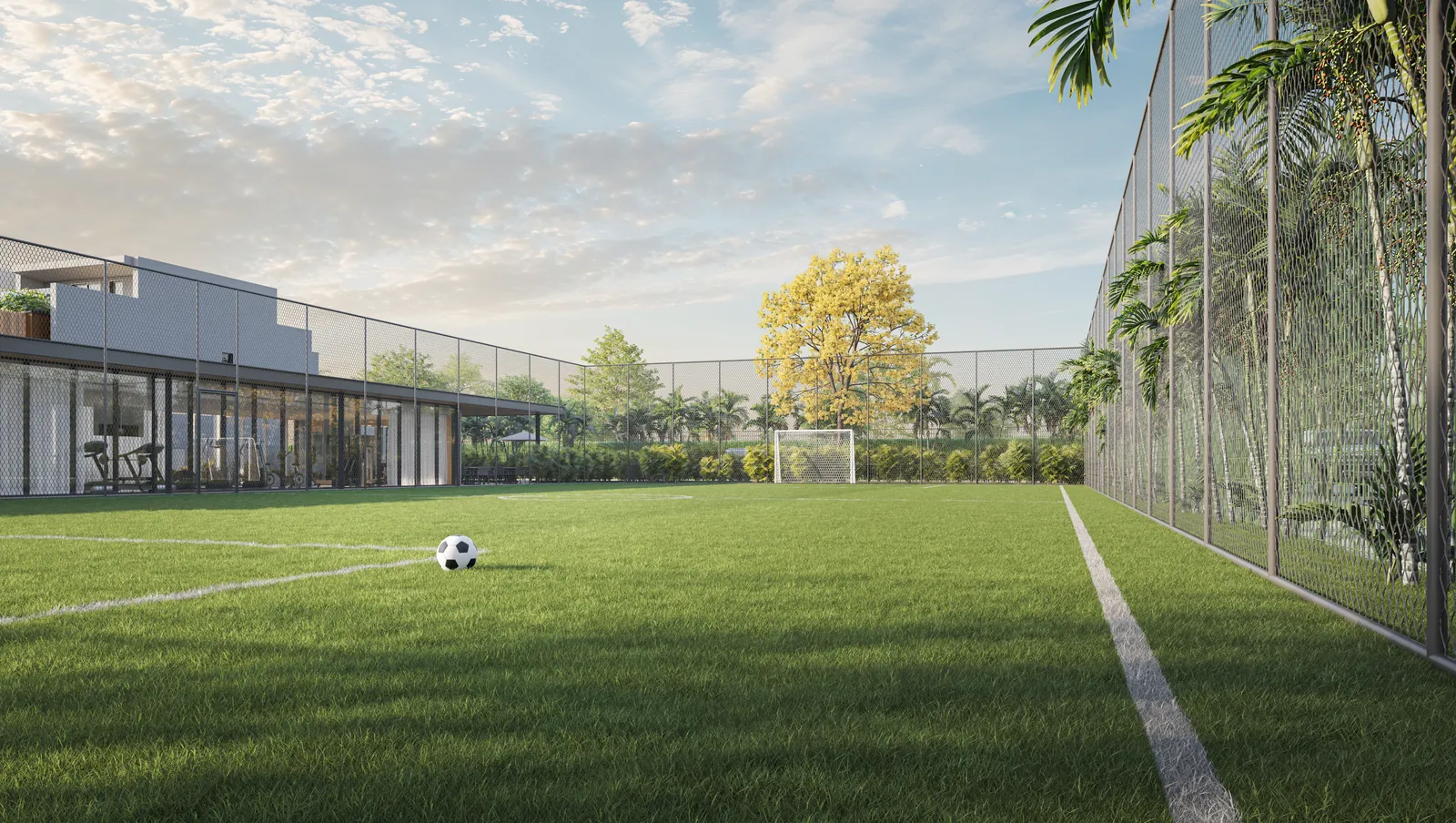 Quadra de futebol com grama sintética e alambrado