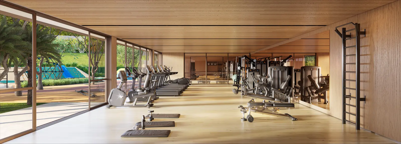 Academia com aparelhos de musculação e vista para o jardim