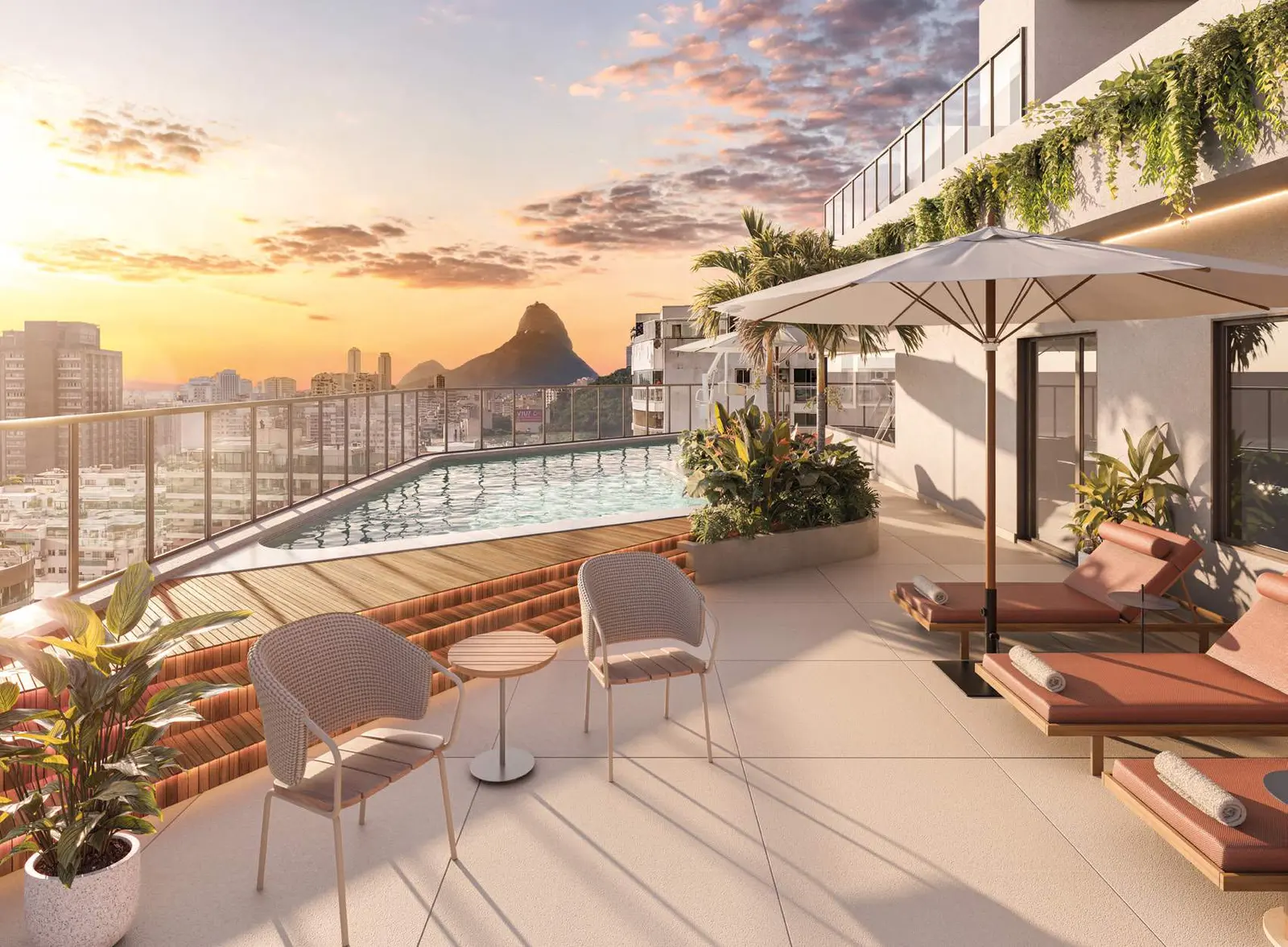 Terraço do rooftop ao entardecer, com poltronas e o Pão de Açúcar ao fundo
